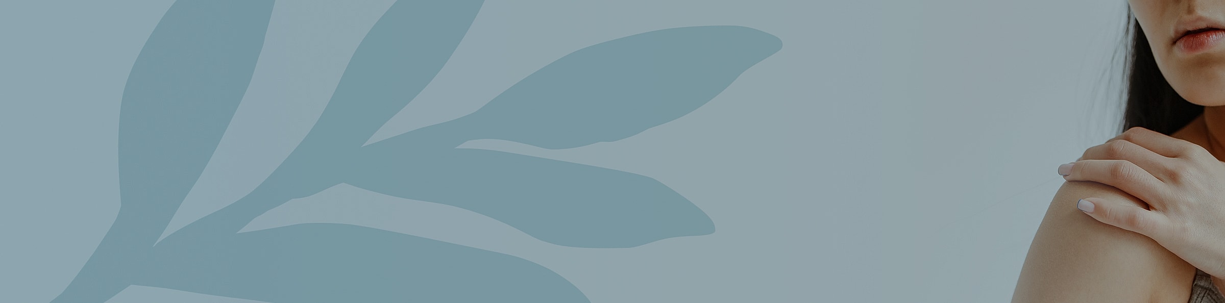 Woman gently touching her shoulder with leaves background.