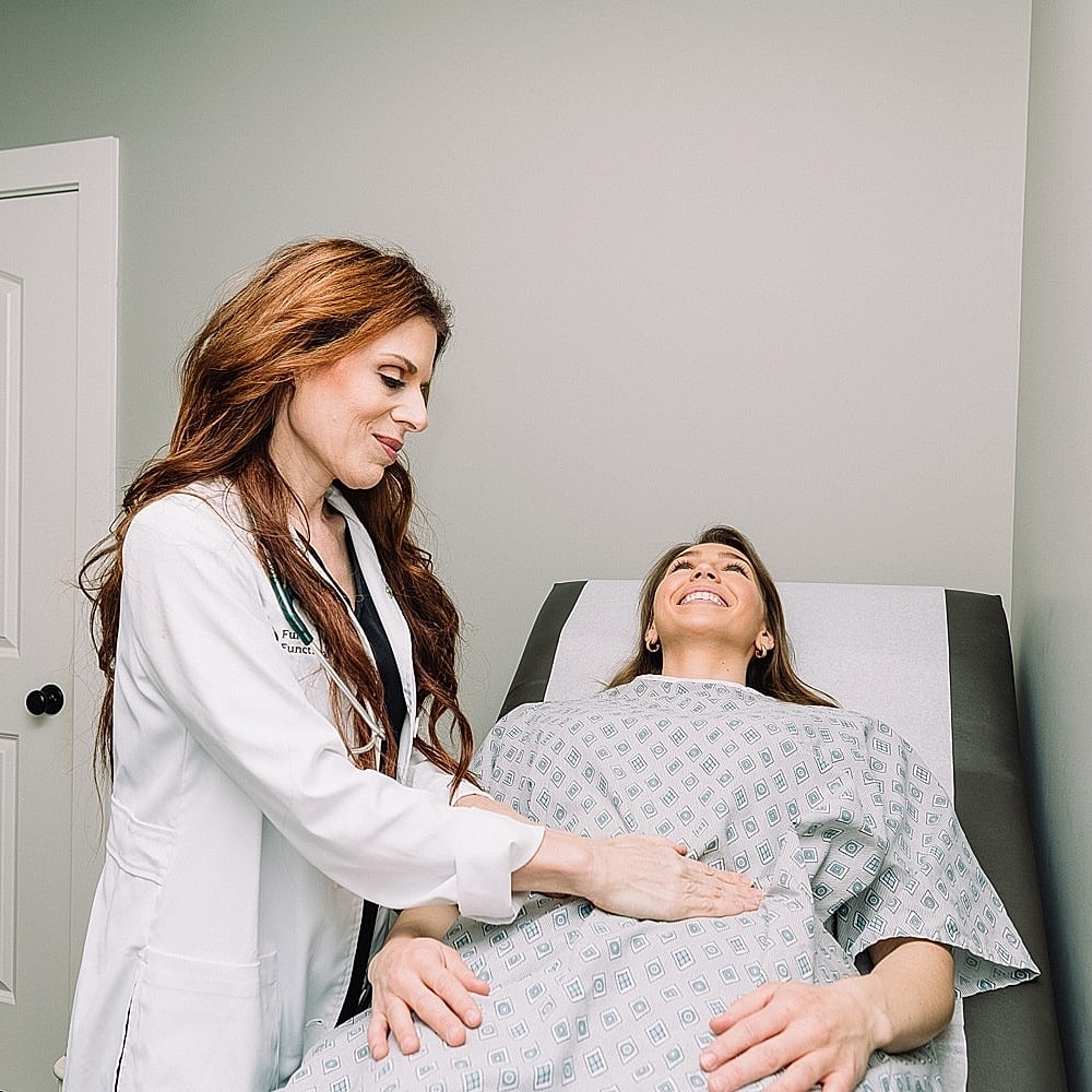 Doctor examines patient in medical office.