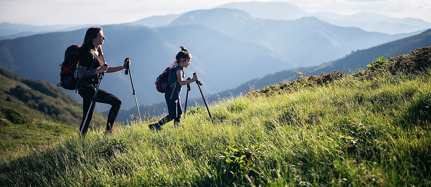 Mother and daughter hiking in the mountains.