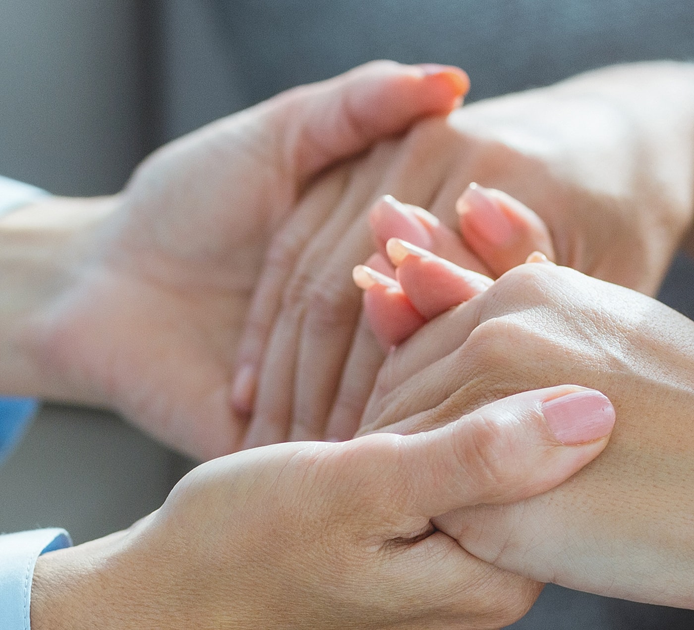Hands holding each other softly in support.