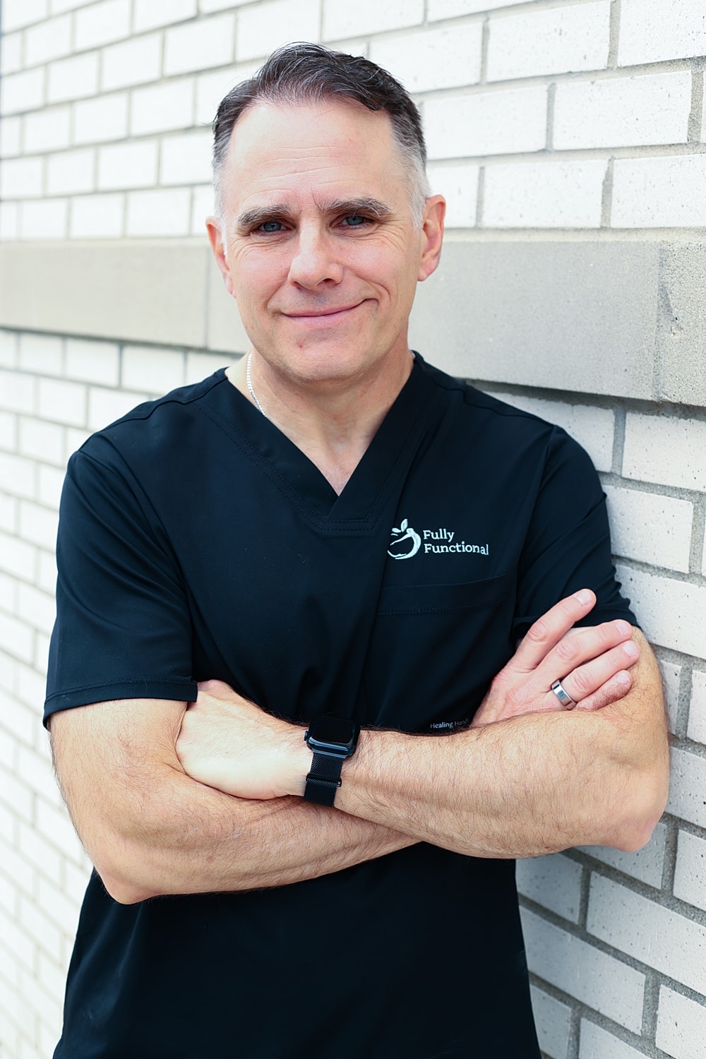 Confident healthcare professional in black scrubs.