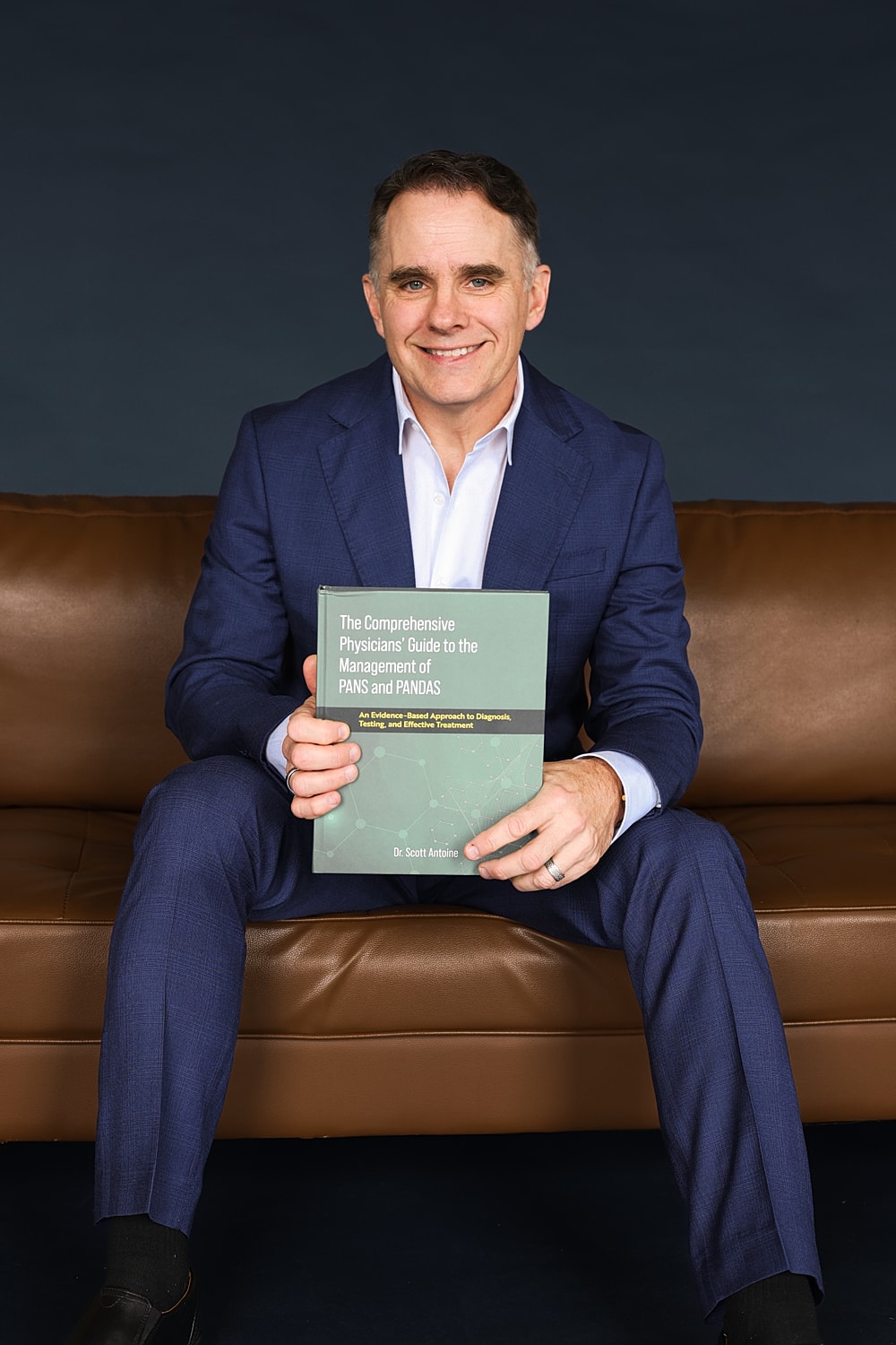 Man holding book about PANS and PANDAS.
