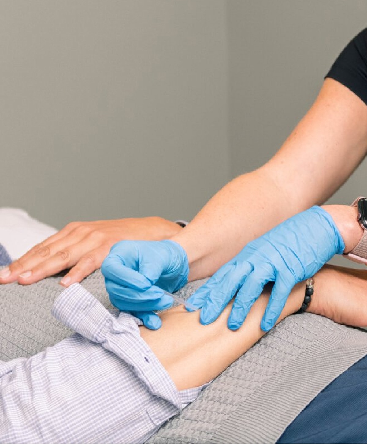 Person receiving an injection in a medical setting.