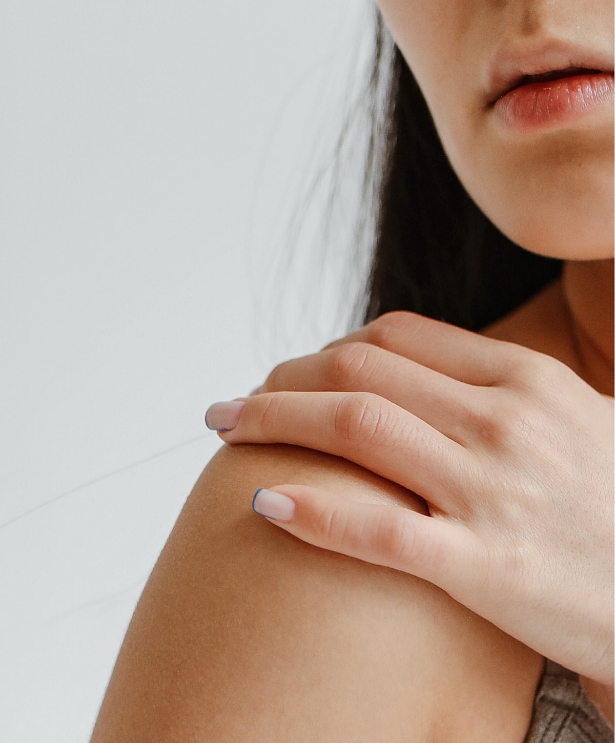 Close-up of a hand on a shoulder.