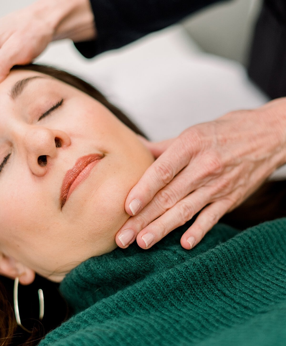 Facial treatment session with a relaxed woman.