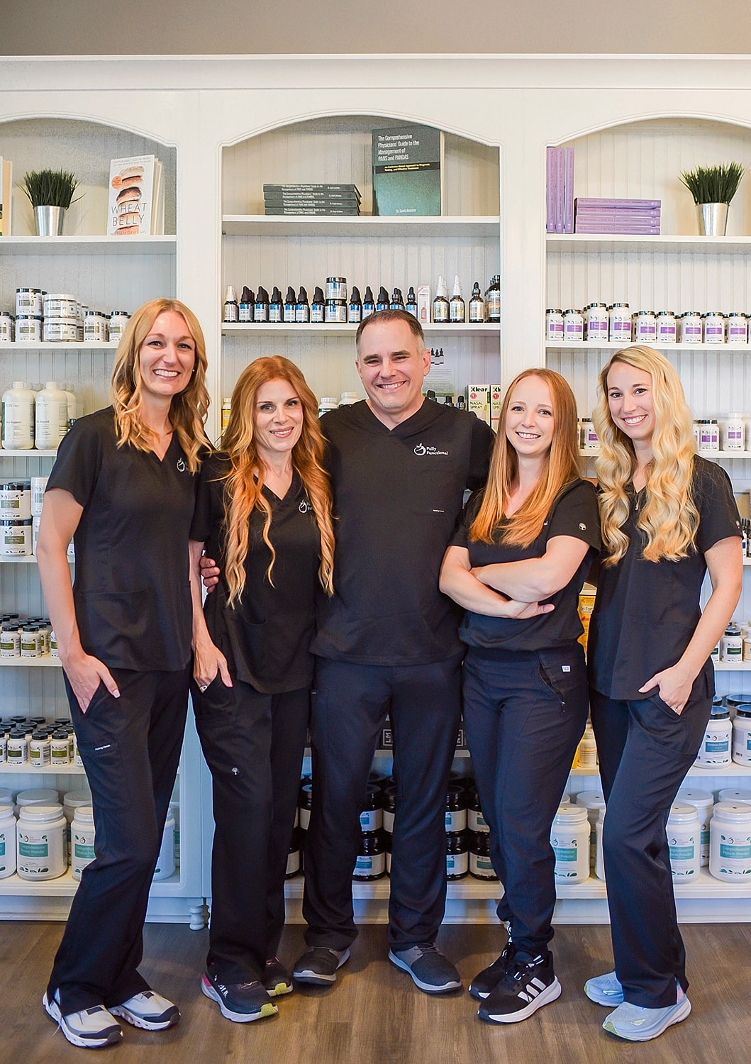 Wellness team posing in professional attire.