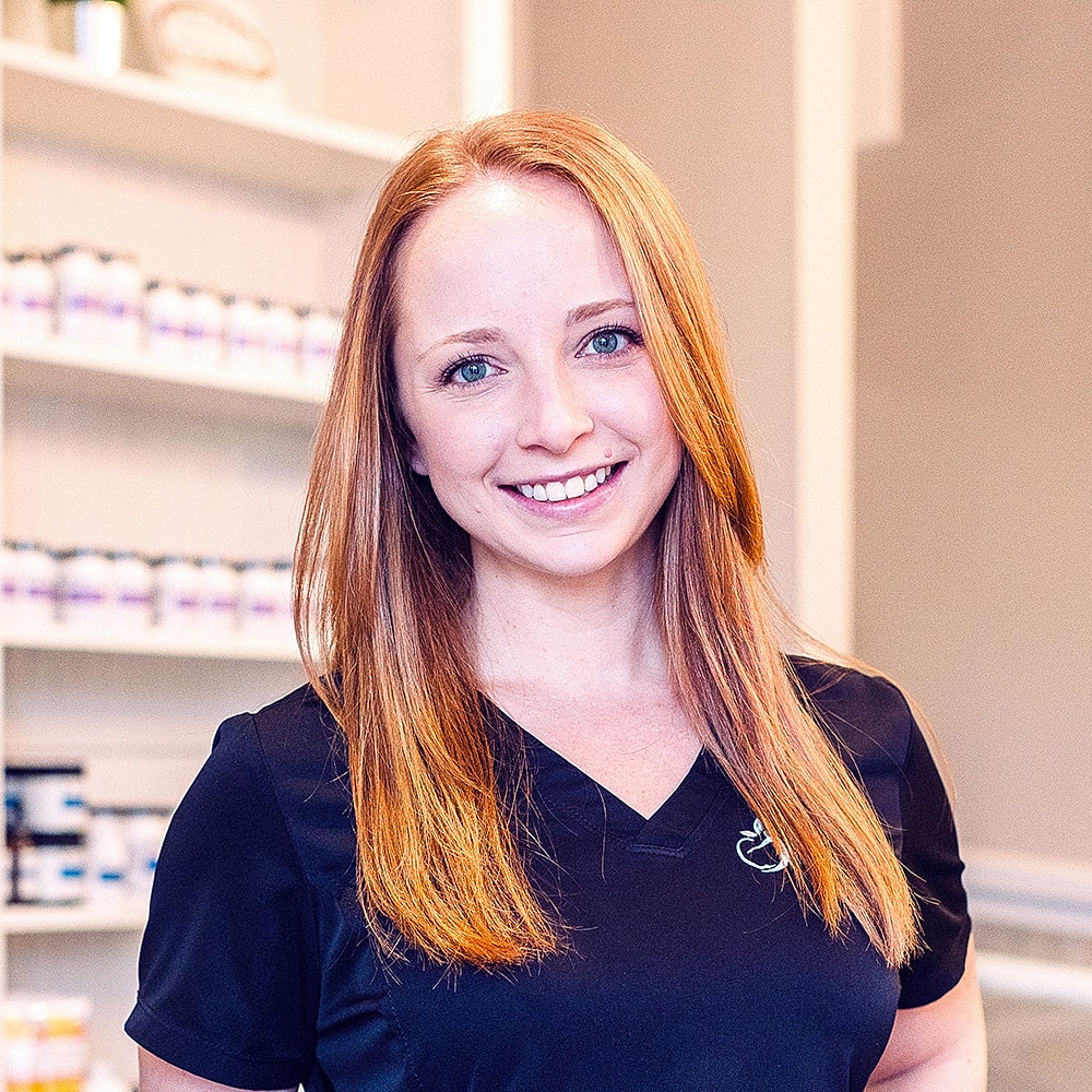 Smiling professional in a wellness environment.