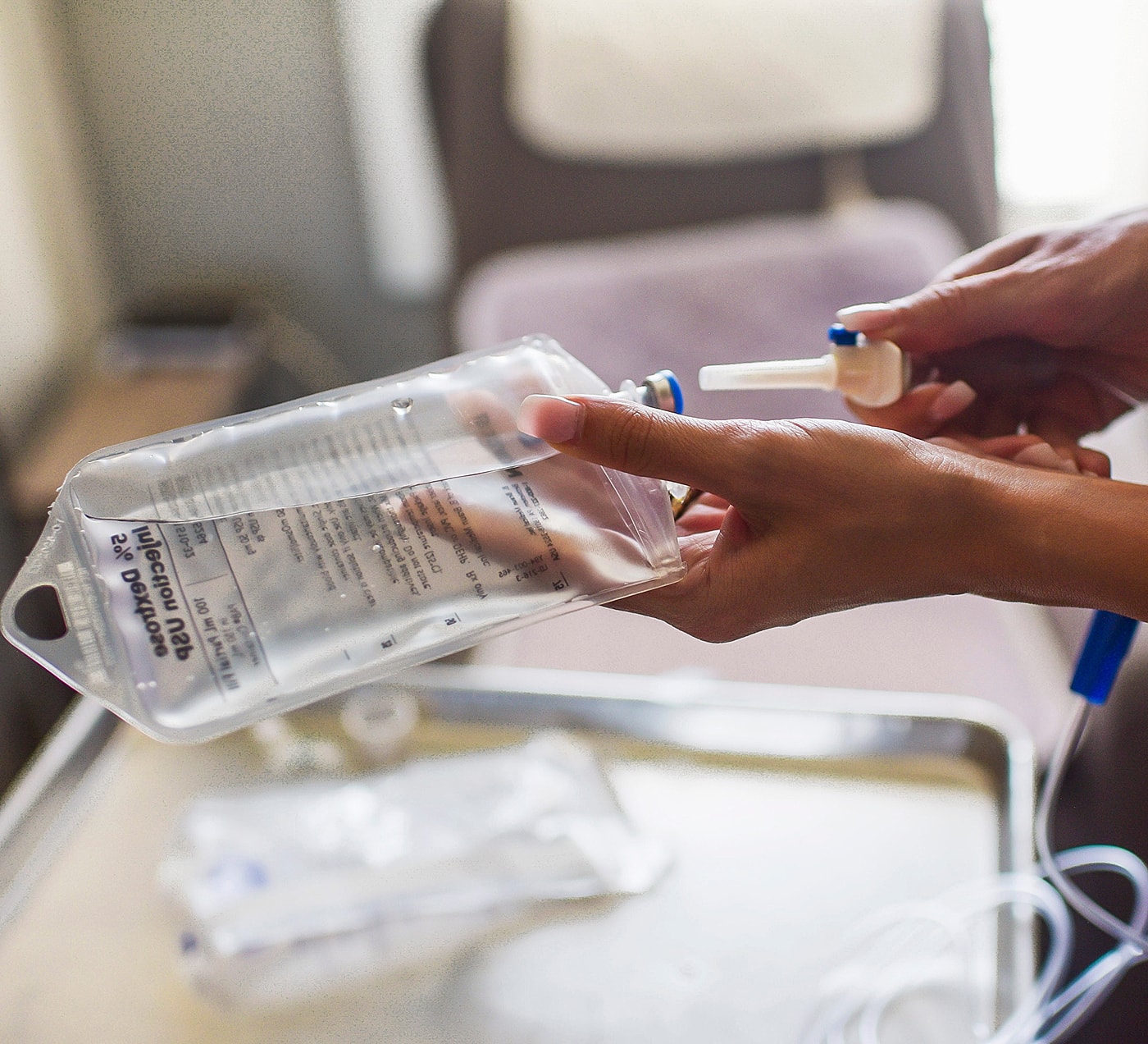 Person holding IV bag with medication instructions.