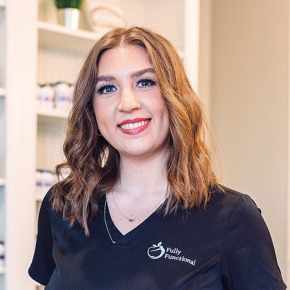 Smiling woman in professional attire indoors.