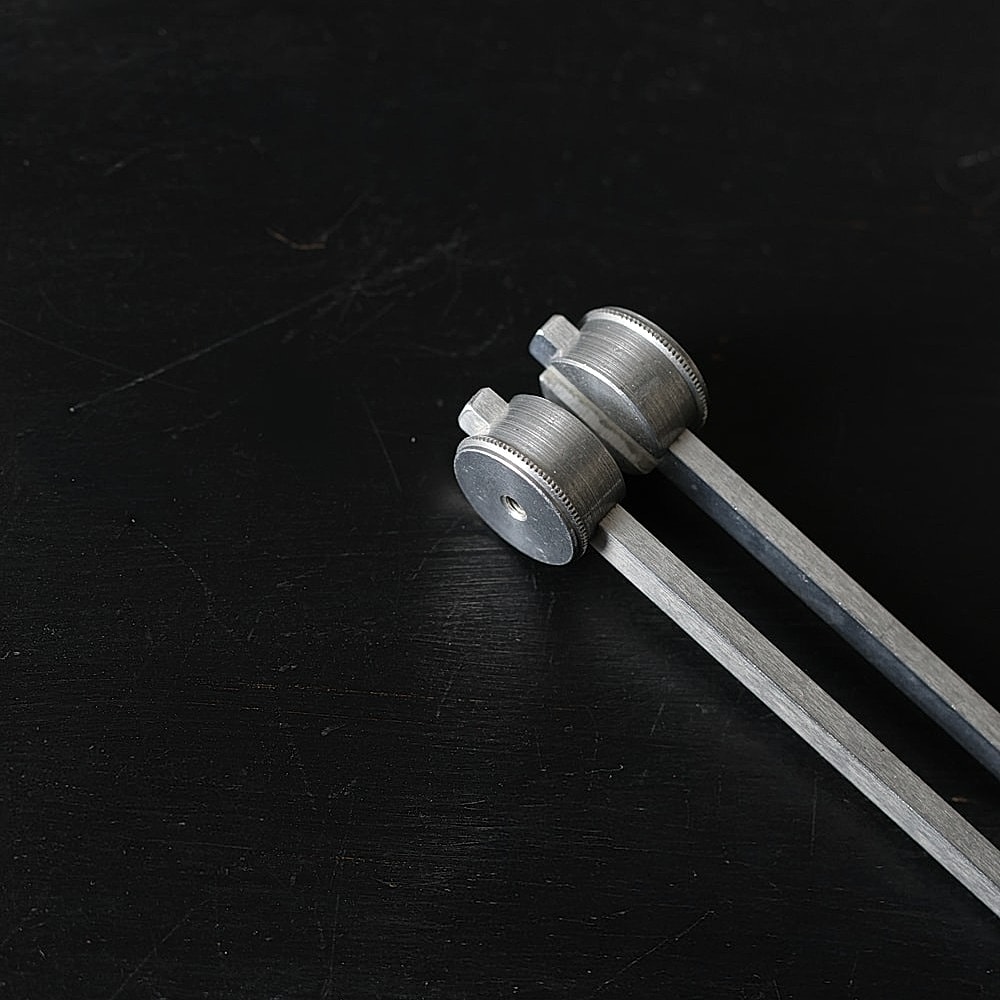 Metal tools on a dark surface.