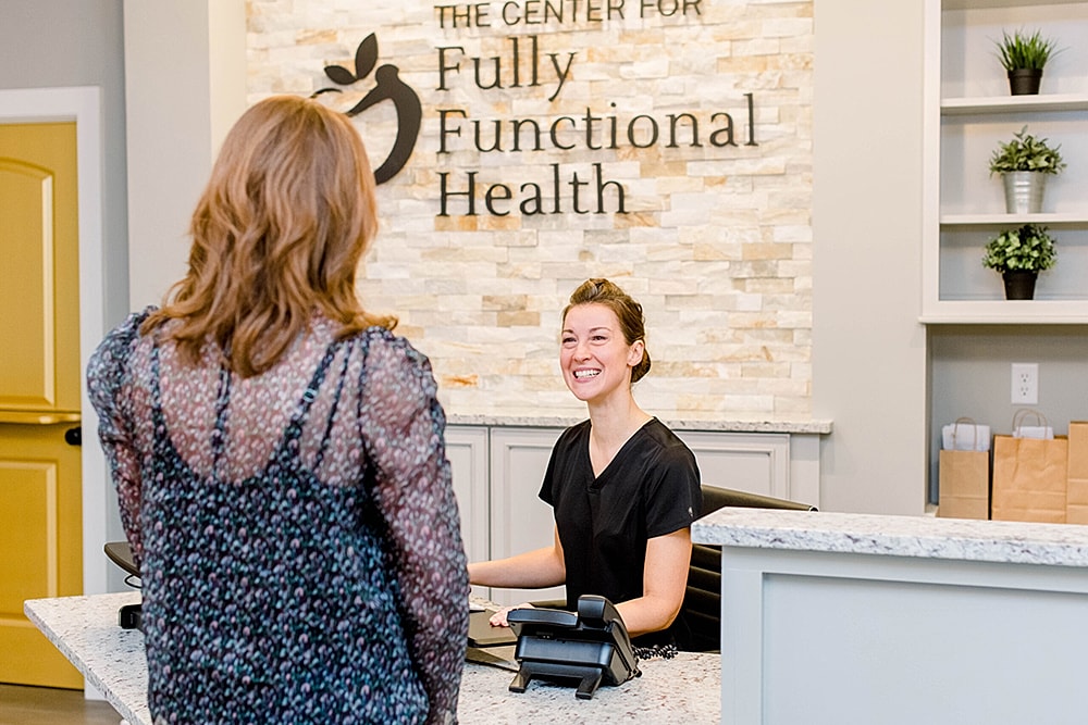 Receptionist welcoming a client at health center.