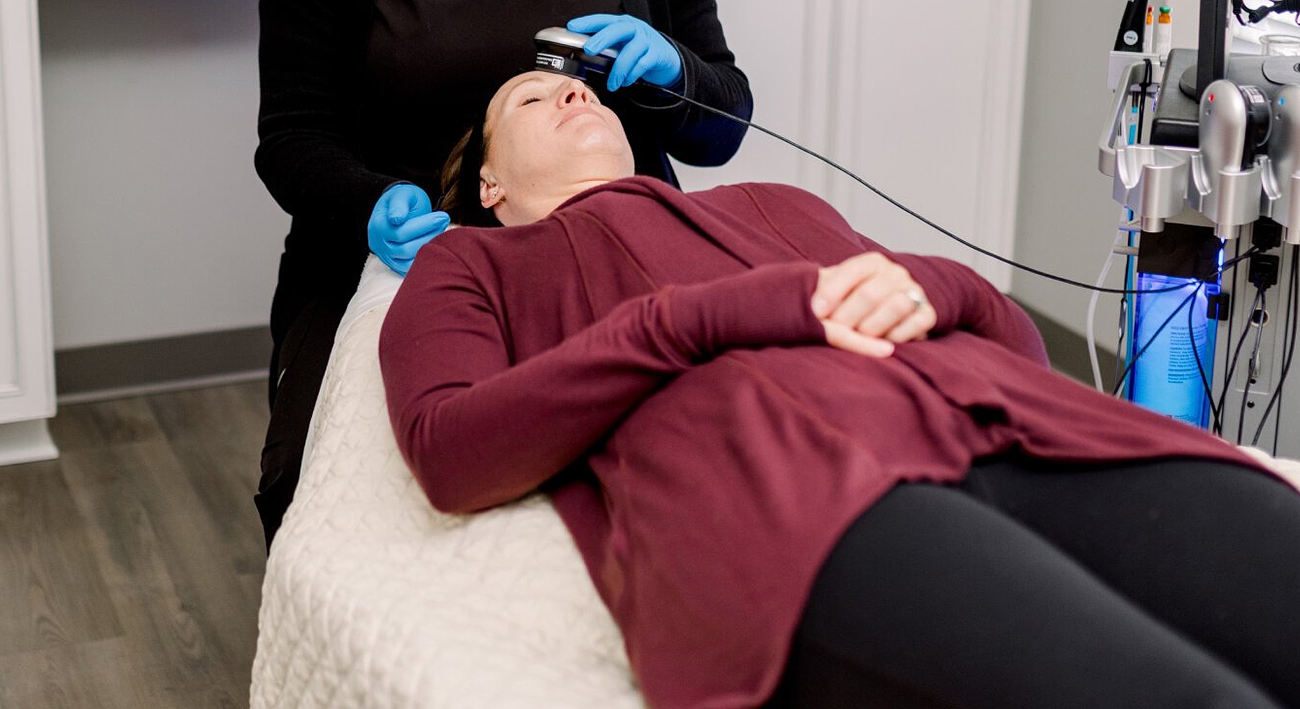 Woman receiving a facial treatment at a clinic.