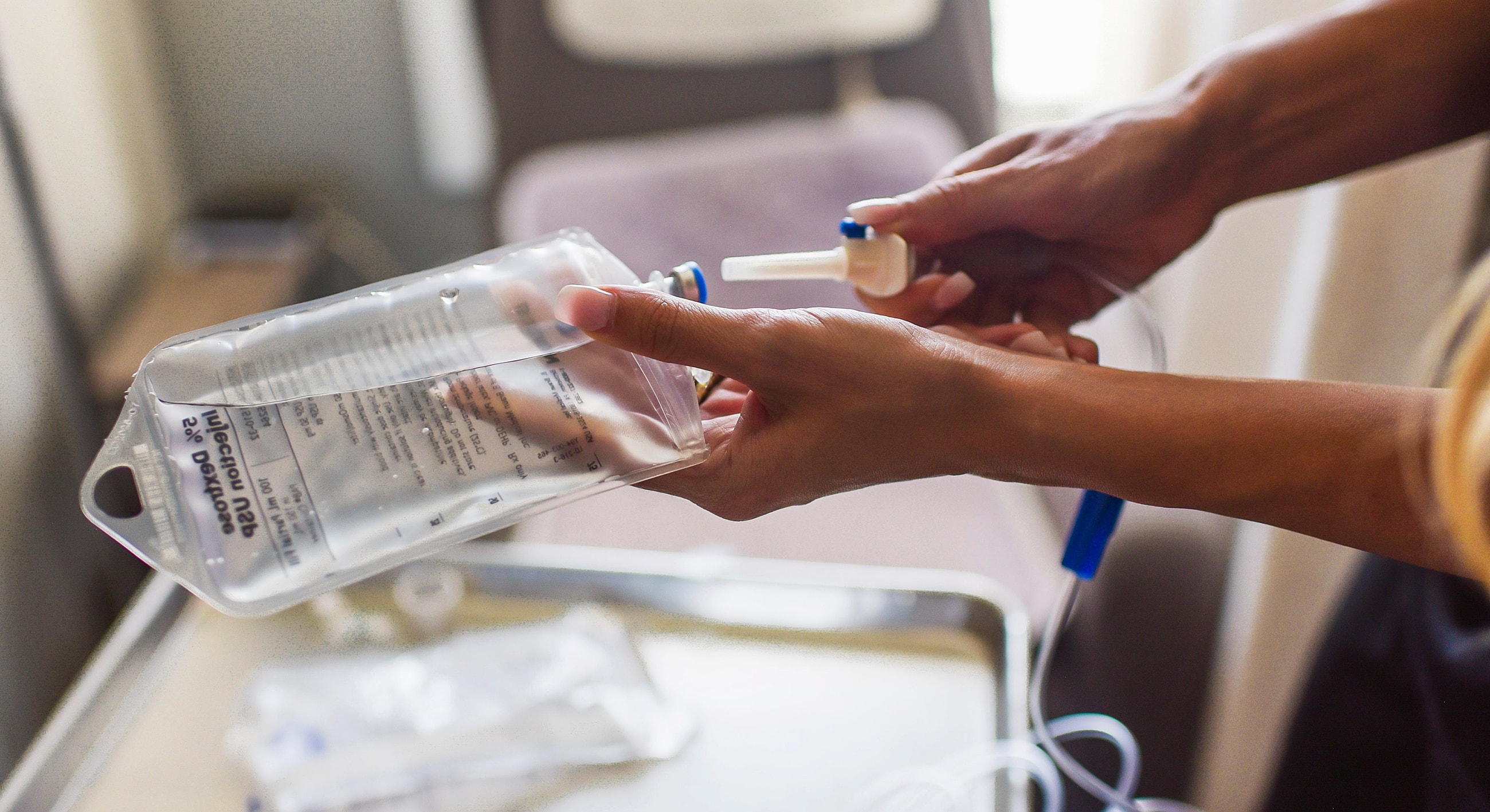 Preparing intravenous fluid for administration.