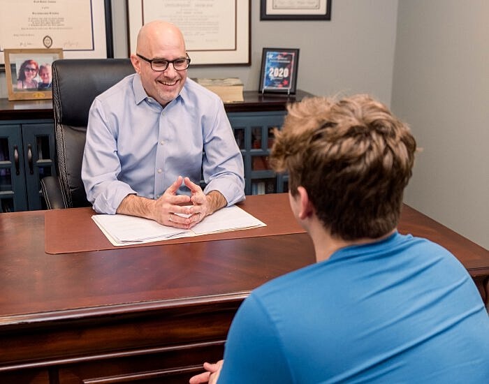 Counselor meeting with a young client in office.